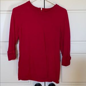 Red sweater with bow accent on sleeve